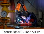 Man welder. Soldering equipment in hands of guy. Welder at work. Industrialist works with welding. Welder in protective mask. Metal processing plant. Soldering apparatus of man worker.