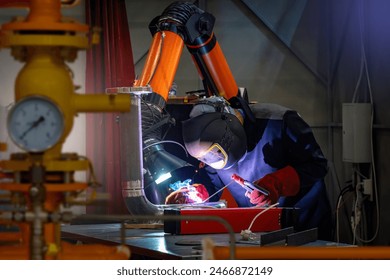 Man welder. Soldering equipment in hands of guy. Welder at work. Industrialist works with welding. Welder in protective mask. Metal processing plant. Soldering apparatus of man worker. - Powered by Shutterstock