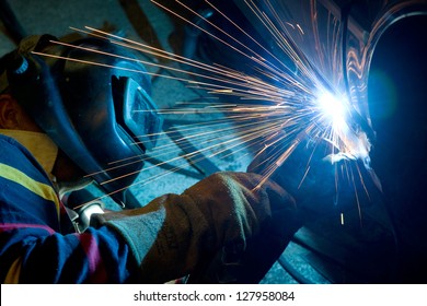 Man Welding A Car