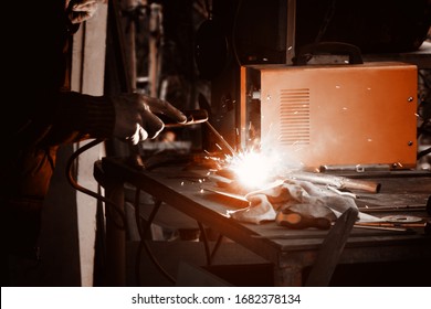 Man Welding Old Shovel, Close Up