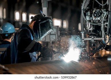 man welds at the factory - Shutterstock ID 539932867
