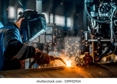 man welds at the factory - Shutterstock ID 539932924
