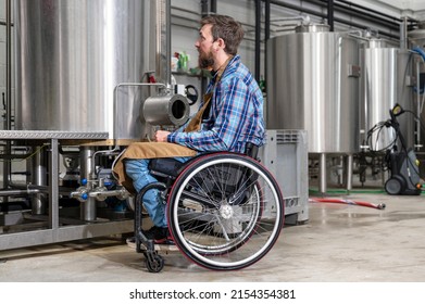 Man in wheel chair working in Brewery factory. High quality photography