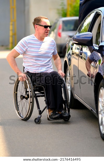a man in a wheelchair approached the passenger car\
from the passenger door