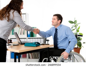 Man In Wheelchair Is Greeting A Woman In The Office