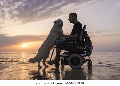 Man in a wheelchair and his dog sitting on a dock and enjoying a stunning sunset over the open sea. Disability lifestyle concept. - Powered by Shutterstock