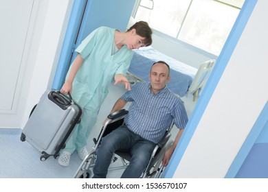 Man In Wheelchair Leaving Hospital