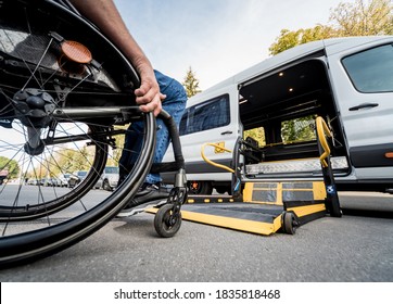 A man in a wheelchair moves to the lift of a specialized vehicle 