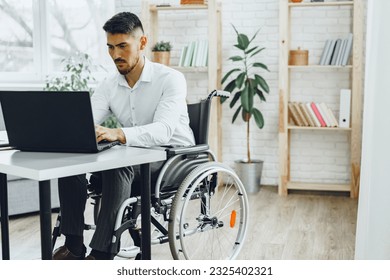 man in wheelchair using his laptop for work seeking a job in internet - Powered by Shutterstock