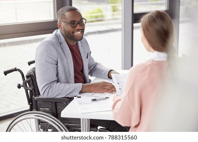 Man In Wheelchair Work In His Own Company As Director, Gives Commands And Instruction To Female Secretary, Happy To Receive High Profit