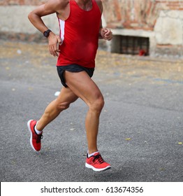 man while running on the asphalt road in the city