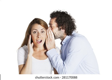 Man Whispering In Woman's Ear