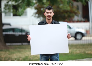 man with a white board on hands, for advertising, male student poster ad