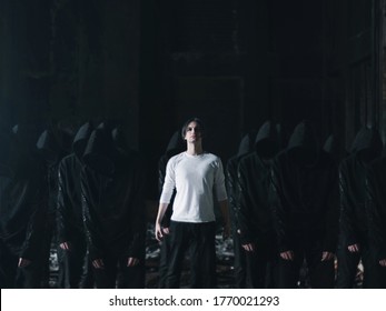 Man In White With Followers In Black Cult Concept