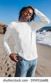 Man In White Long Sleeve Tee Walking On The Beach