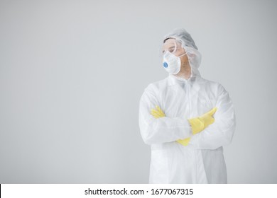 Man In White Protective Suit, Mask, Glasses And Gloves Is Coughing On White Background, Coronavirus Pandemic Threat. Epidemic, Pandemic Of Coronavirus Covid 19. Doctor, Patient In Respirator.