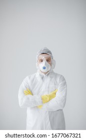 Man In White Protective Suit, Mask, Glasses And Gloves Is Coughing On White Background, Coronavirus Pandemic Threat. Epidemic, Pandemic Of Coronavirus Covid 19. Doctor, Patient In Respirator.