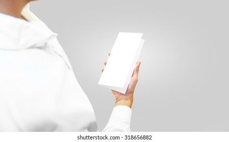 Man In White Shirt Holding Blank Brochure Booklet In The Hand. Person Shows Flier Template, Layout, Advertisement. Flyer In Hands. Booklet Design.