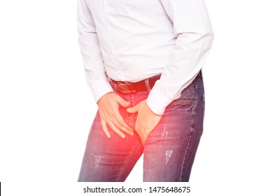 A Man In A White Shirt Holds On To His Groin, The Concept Of Pain And Inflammation In The Groin, Genital Infections In Men And Prostatitis. White Background, Isolate