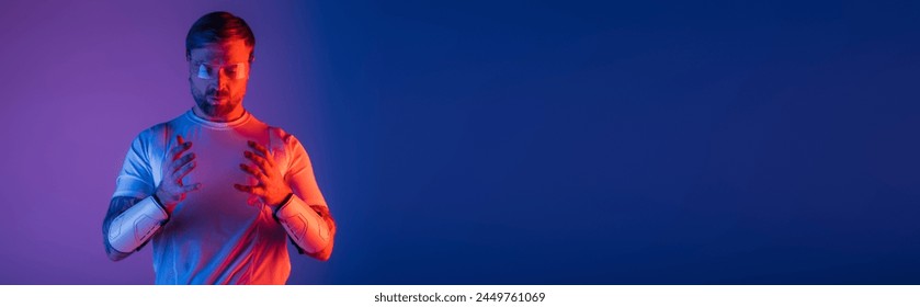 A man in a white shirt stands calmly, holding his hands together in a peaceful gesture in a virtual reality studio. - Powered by Shutterstock