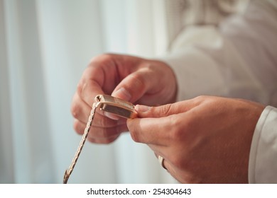 The man in the white shirt in the window wears a gold watch. - Shutterstock ID 254304643