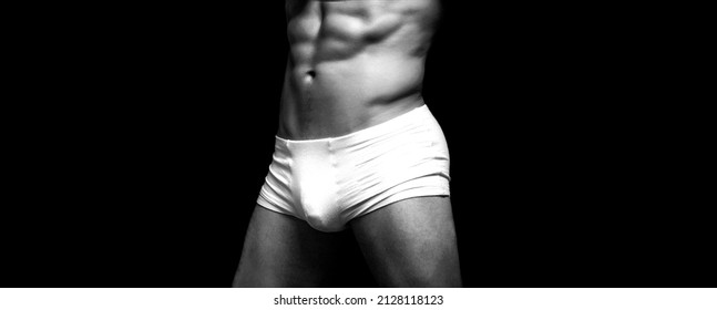 Man In White Shorts. Handsome Muscular Macho In White Underwear. Male Swimwear, Shorts, Underwear, Concept. Black And White.