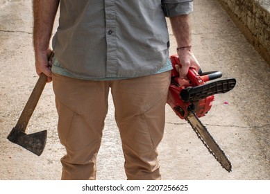 
Man Who Can't See His Face, In One Hand The Ax In The Other The Chainsaw, Halloween, Murderer Or Lumberjack