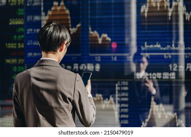 A man who checks the Nikkei Stock Average - Shutterstock ID 2150479019