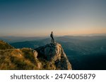 A man who hikers enjoys a break look at the top of the mountain at sunset or sunrise adventure travel. 