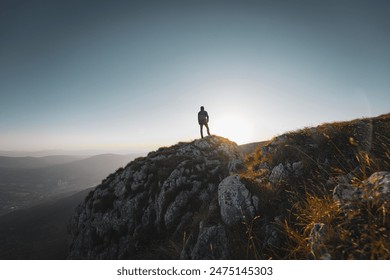 A man who hikers enjoys a break look at the top of the mountain adventure travel.  - Powered by Shutterstock