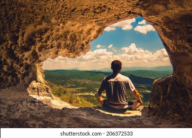 The man who meditates in a cave overlooking the mountain valley