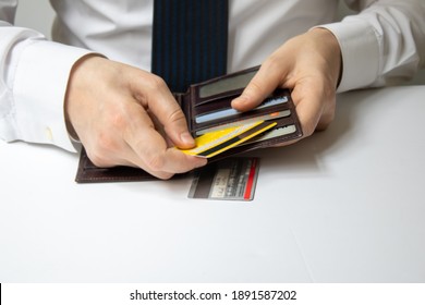 The Man Who Puts His Credit Card In The Wallet. Credit Card Usage. Conscious Consumers. Consumer Shopping Habits. The White Background Is Also Photographed Close-up.