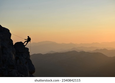 The Man Who Rock Climbing In A Wonderful Sunset - Powered by Shutterstock