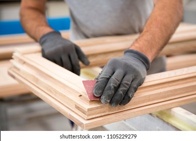 Man Who Is Sanding A Window Frame