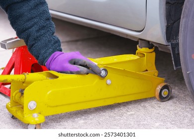 A man who is working on tire replacement