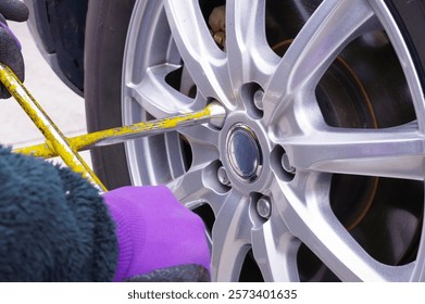 A man who is working on tire replacement