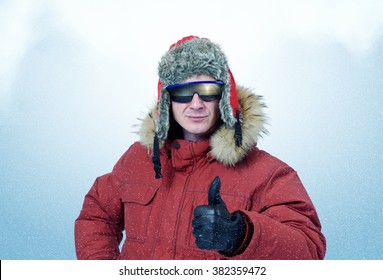 Man In Winter Clothes And Sunglasses It Shows Thumb. Polar Explorer