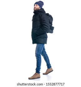 Man In Winter Jacket And Warm Hat, With Backpack Walking Goes On White Background Isolation