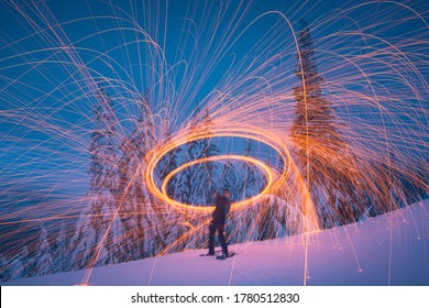 Man In A Winter Snowy Forest Painting By Light With Steel Wool. Breathtaking Picture.