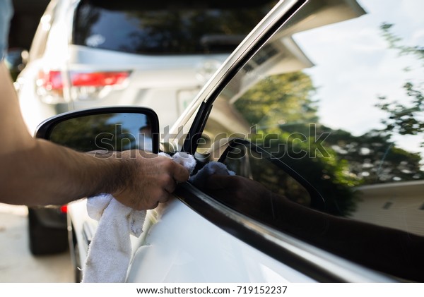 Man with wipe car glass
cleaner