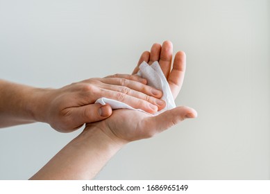 Man Wipes His Hands With A Antibacterial Alcohol Wet Wipe. Coronavirus And Rotavirus Prevention