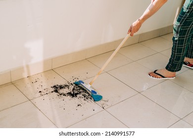 Man Wiping Floor With The Mop. Janitor Washing The Dirty Floors. Guy Mopping The Balcony On A Sunny Day. Person Doing Home Chores. Young Fellow Using Cleaning Equipment To Dust The Surface.