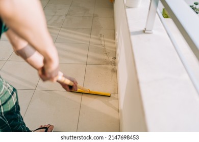 Man Wiping Floor With The Mop. Janitor Washing The Dirty Floors. Guy Mopping The Balcony On A Sunny Day. Person Doing Home Chores. Young Fellow Using Cleaning Equipment To Dust The Surface.