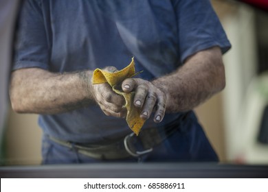 The Man Is Wiping His Dirty Hands. Body Shop