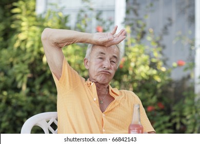 Man Wiping Sweat From His Forehead