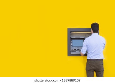 Man withdrawing money from an atm bank machine