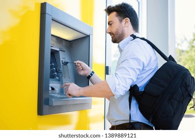 Man Withdrawing Money From An Atm Bank Machine