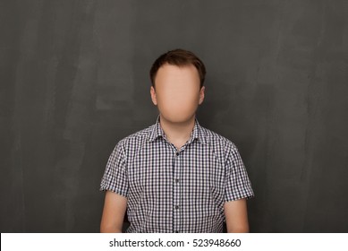Man Without a Face. The guy in a checkered shirt without a face against a black wall. strange unusual portrait of the dude. self-portrait artist photographer