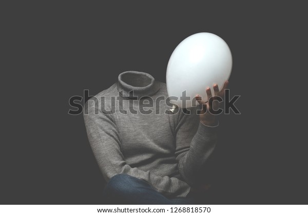 man without head\
holding white balloon