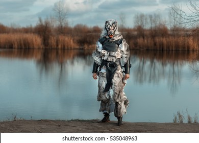 Man Wolf Werewolf, Stands On The Background Of The Lake.